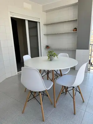a white table and chairs with a plant on it at 1st Line Beach Direct Access Private Parking in Valencia