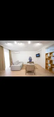 a living room with a couch and a table at Habitación El Cabanyal in Valencia