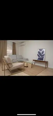 a living room with two chairs and a glass table at Habitación El Cabanyal in Valencia