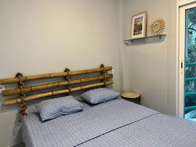 a bedroom with a bed with two pillows on it at Luxury villa with swimming pool in the forest in Gilet