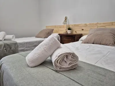 a bedroom with two beds with towels on them at PINEDO PLAYa in Valencia