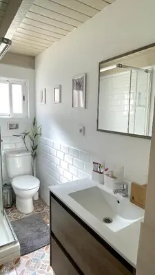 a bathroom with a sink and a toilet and a mirror at Apartamento Joaquín Sorolla - Patraix in Valencia