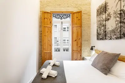 a bedroom with a bed with two teddy bears on it at AIRE Holidays Valencia in Valencia