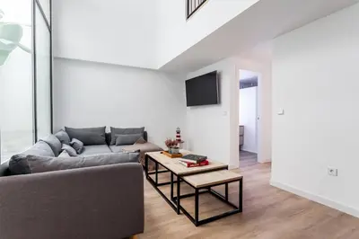 a living room with a couch and a table at AIRE Holidays Valencia in Valencia
