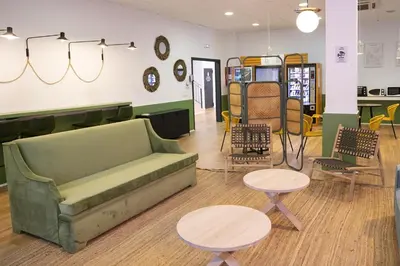 a living room with a couch and two tables and chairs at MiCampus Burjassot 1 Student Residence in Burjasot