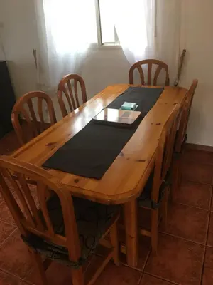 a wooden table with chairs and a black napkin on it at Casa Ramona in Valencia