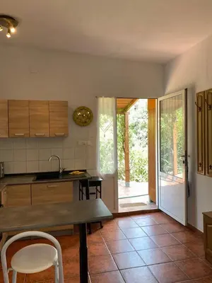 a kitchen with a table and a door to a patio at Casa Ramona in Valencia