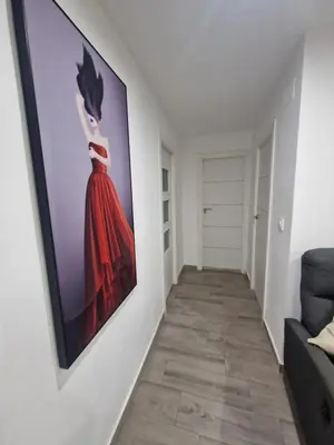 a hallway with a painting of a woman on a wall at Relax Zone Cullera Parking fee en edificio in Cullera
