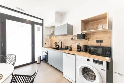 a kitchen with a washer and dryer at Loft Urban Beach - Cerca del Mar in Valencia