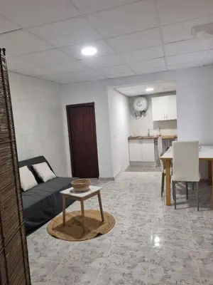 a room with a bed and a table and a kitchen at Rural studio in Cortez de Pallas