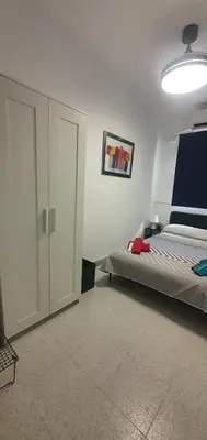 a bedroom with a bed and a sliding door at Céntricas, Tranquilas y Acogedoras Habitaciones de Matrimonio en Vivienda Compartida in Valencia