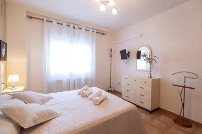 a bedroom with a bed with two towels on it at Casa Potelos by Concept Flats in Navajas