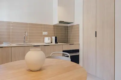 a vase sitting on a wooden table in a kitchen at GuestReady - Reental Apartments in Valencia