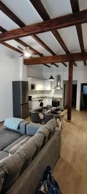 a living room with a couch and a kitchen at Beachside apartment in Valencia