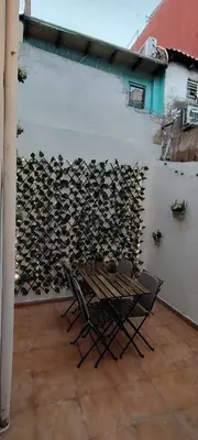 a room with a table and chairs next to a wall at Beachside apartment in Valencia
