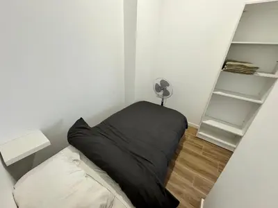a bedroom with a bed with a black pillow at Habitacion privada con baño privado III in Valencia