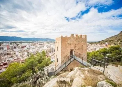 a building on top of a hill with a city at Casita con vistas al Castillo de Cullera in Cullera