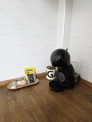 a black helmet sitting on the floor next to a plate of food at La Marina de Coup de Coeur Appartments in Valencia