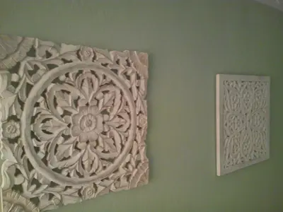 two pieces of art on a green wall at Ca'l Suecà in Chella