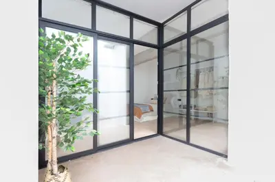 a room with glass doors and a tree at Manya Valencia by Concept Flats in Valencia