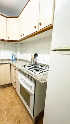 a kitchen with a stove and a refrigerator at Kmilo in Valencia
