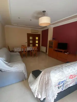 a bedroom with two beds and a dining room with a table at Casa Flare Apartmento para 6 personas en Cheste in Cheste