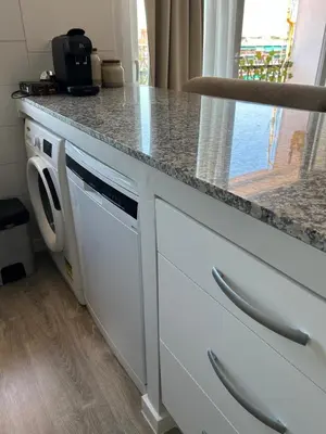 a kitchen with a washing machine under a counter at District Key - Valencia, Manuel Candela in Valencia