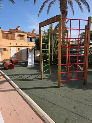 a playground with an open gate in a parking lot at Ca Ulises Frente al mar, pensado para desconectar in Valencia