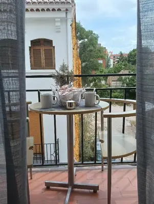 a table on a balcony with a view at El Molino 2 Buñol Apartamento in Buñol