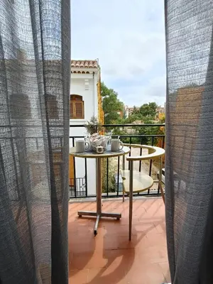 a balcony with a table and a view at El Molino 2 Buñol Apartamento in Buñol