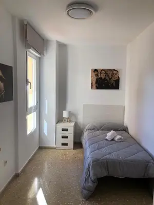 a bedroom with a bed with a blue comforter at Torres del Saler, Gola de Puchol, Valencia in Valencia
