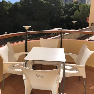 a white table and chairs on a balcony at Torres del Saler, Gola de Puchol, Valencia in Valencia