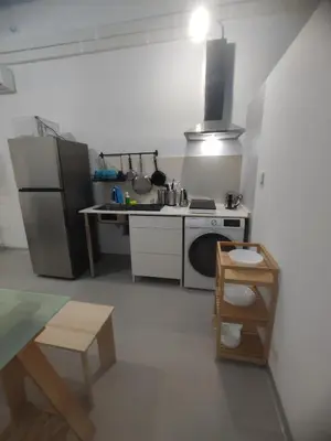 a small kitchen with a stove and a refrigerator at Confortable apartamento cerca de la playa in Valencia