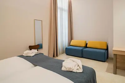 a bedroom with a bed and a table with a tv at Hotel San Lorenzo Boutique Catedral in Valencia