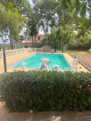 a large swimming pool with chairs in a yard at Casa Perenchiza in Chiva