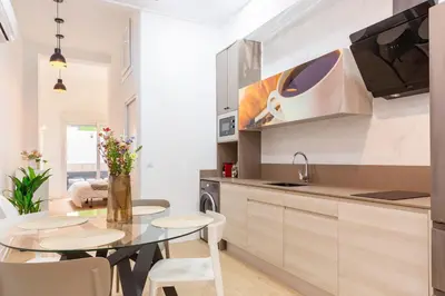 a kitchen with a table and chairs in a kitchen at SingularStays Olimpia in Valencia