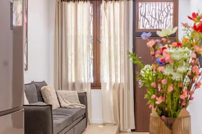 a living room with a couch and a vase of flowers at SingularStays Olimpia in Valencia