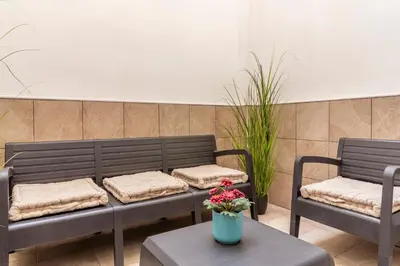 two benches and a table with a vase of flowers at SingularStays Olimpia in Valencia