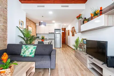 a living room with a couch and a large television at Flats Piera Valencia Center in Valencia