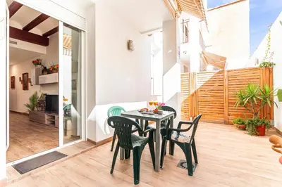 a dining room with a table and chairs on a patio at Flats Piera Valencia Center in Valencia