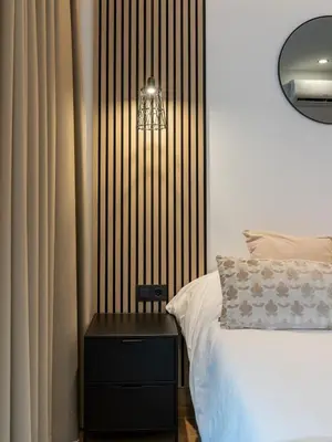 a bedroom with a bed and a side table with a lamp at Dos Corazones in Valencia