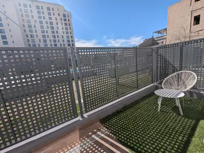 a balcony with a table and a chair at Port Suites Corporate Living Apartments in Valencia