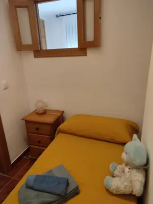 a teddy bear sitting on a bed in a bedroom at Casa Casidro in Chulilla
