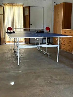 a ping pong table in a room with two chairs at Casa Casidro in Chulilla
