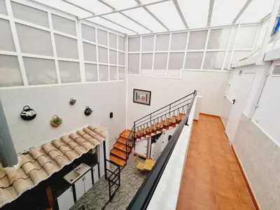 a staircase in a large room with windows and chairs at La Maison du Port in Puerto de Sagunto
