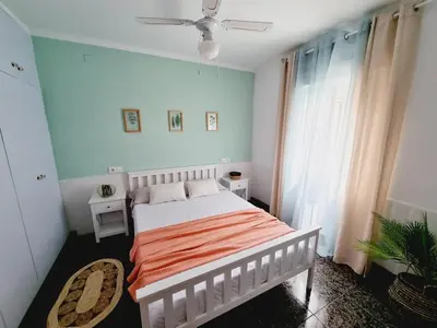 a bedroom with a bed and a ceiling fan at La Maison du Port in Puerto de Sagunto