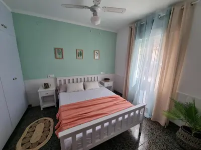 a bedroom with a bed and a ceiling fan at La Maison du Port in Puerto de Sagunto