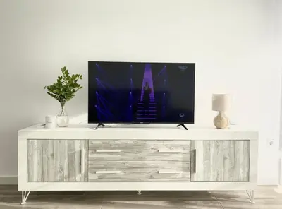 a television on top of a white entertainment center at Beach Apartment in Cullera