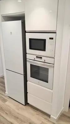 a kitchen with a microwave oven and a refrigerator at Beach Apartment in Cullera