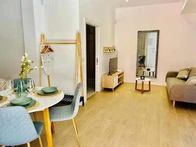 a living room with a table and a couch at Loft Sofia a estrenar con luz natural en corazon de Valencia in Valencia